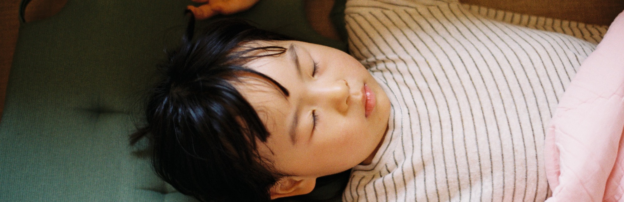 toddler asleep on mattress
