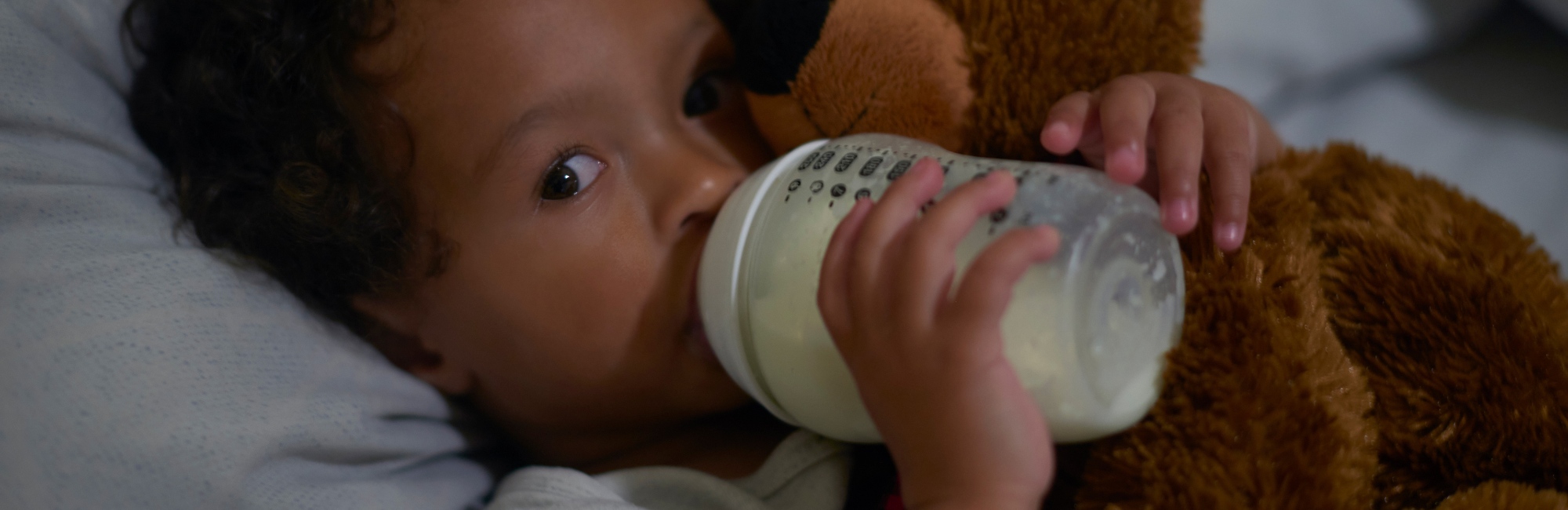 toddler feeds from bottle