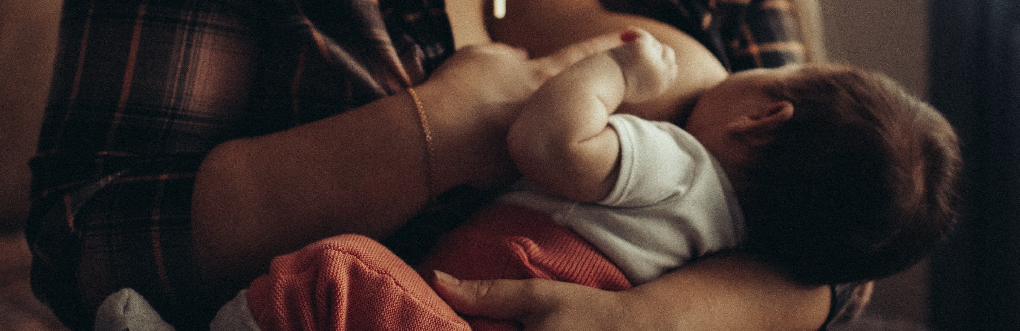 woman breastfeeding a baby in night