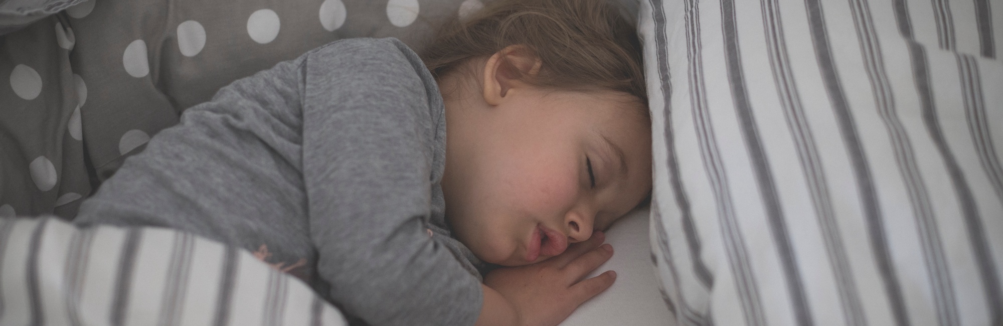toddler sleeping in bed