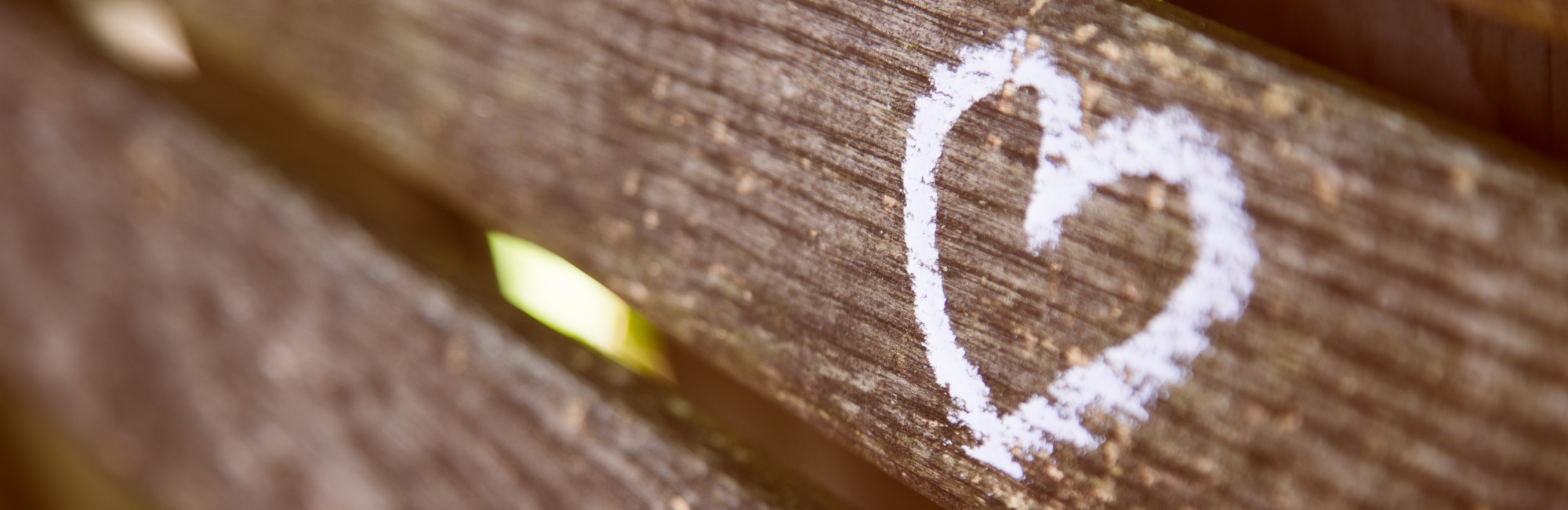 white love heart painted on to beam of wood